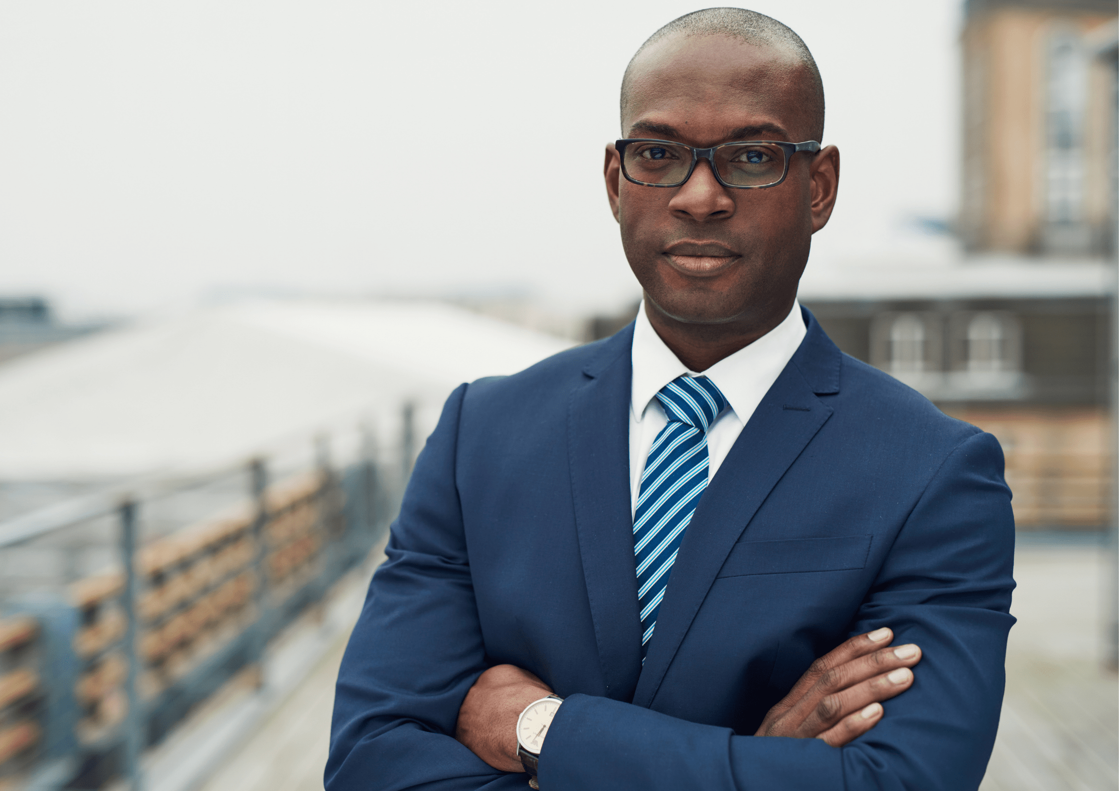 A well dressed man posing in front of the camera